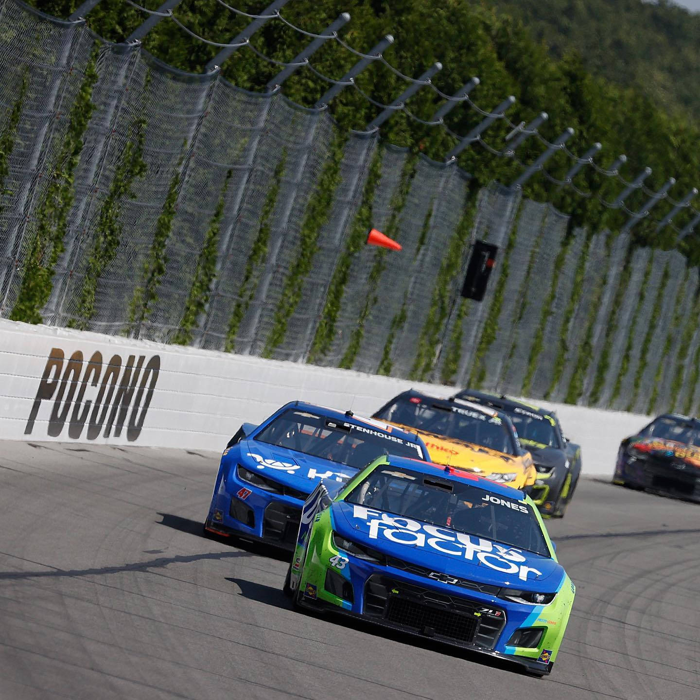 Erik Jones In Front Of Other Cars Background