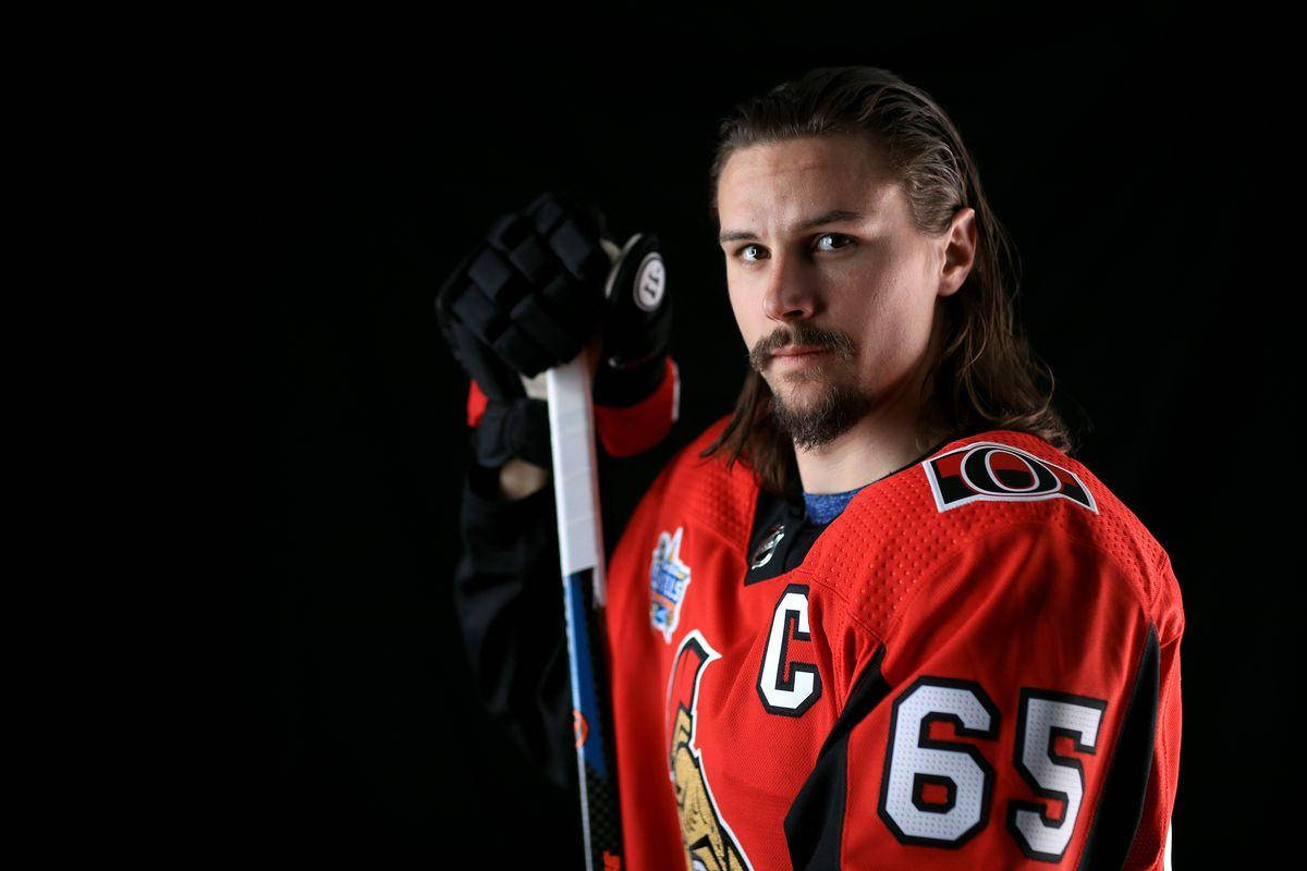 Erik Karlsson In Action On The Hockey Rink Background