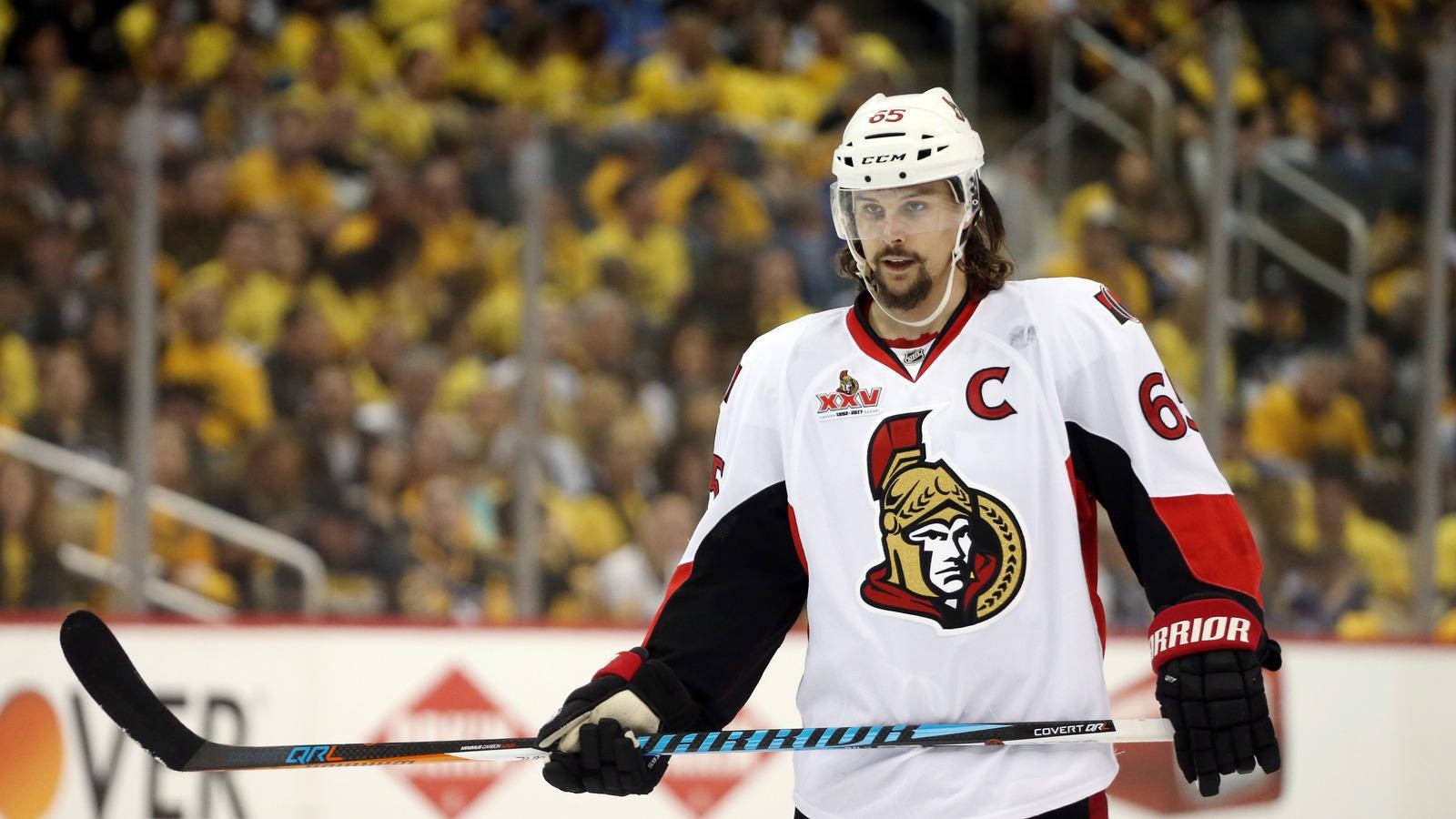 Erik Karlsson In White Ottawa Senators Jersey During A Game Background