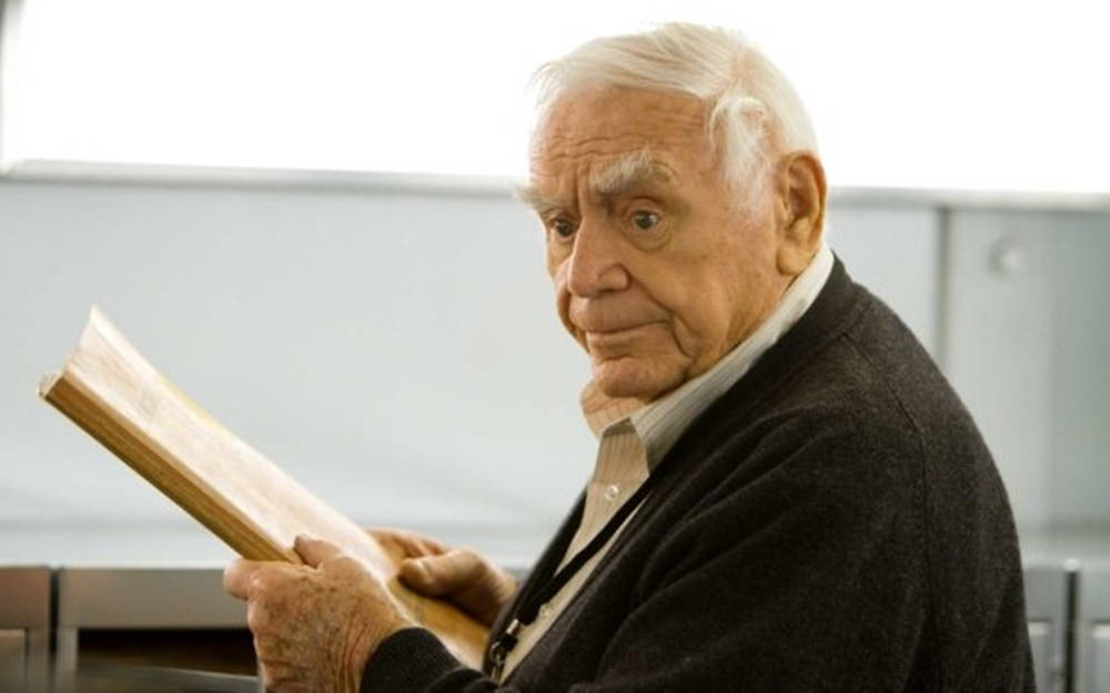 Ernest Borgnine Holding A Book Background