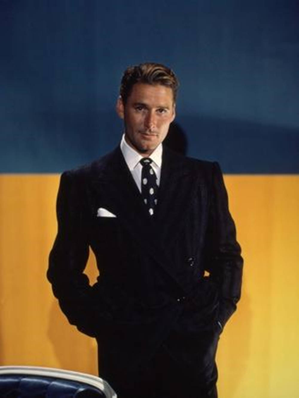 Errol Flynn In Suit Blue And Yellow Background