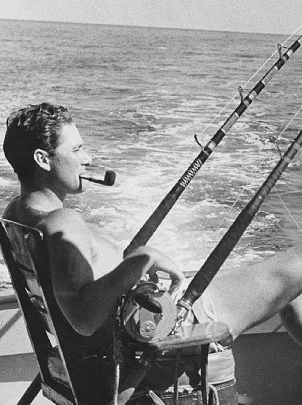 Errol Flynn Smoking Pipe By Water Background