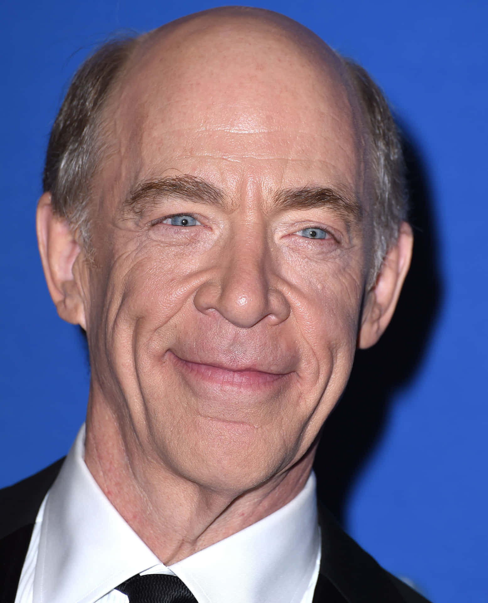Established Actor J.k. Simmons In A Thoughtful Portrait Background