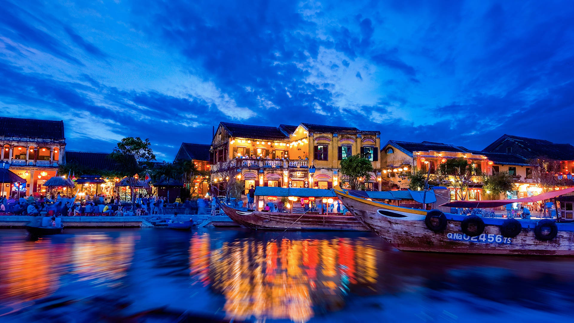 Establishments Along The Riverside At Night Background