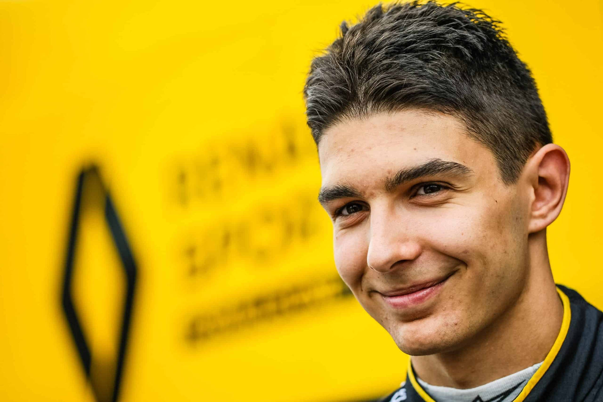 Esteban Ocon Against Blurry Yellow Backdrop