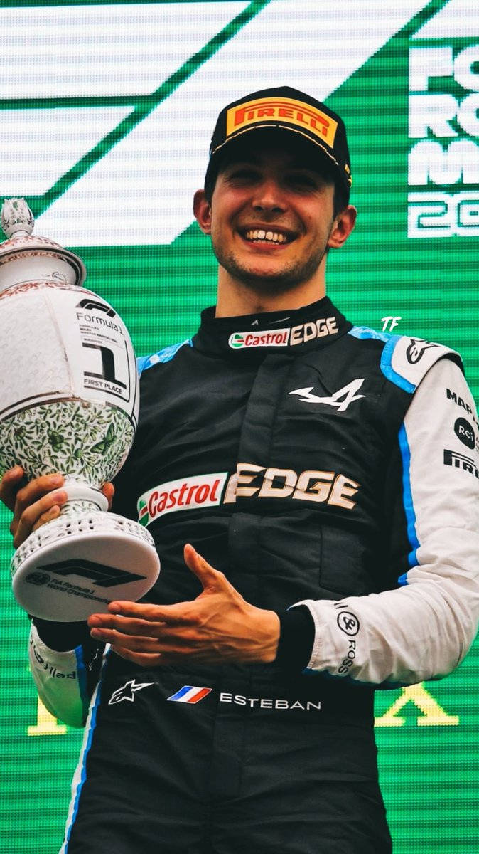 Esteban Ocon Holding Race Trophy Background