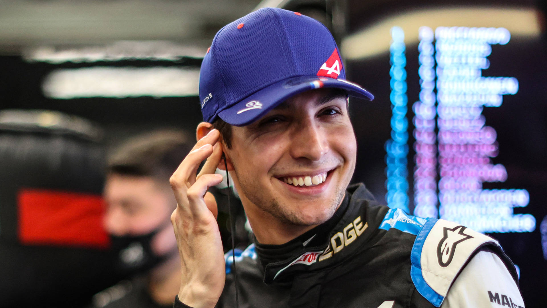 Esteban Ocon Wearing Blue Cap Background