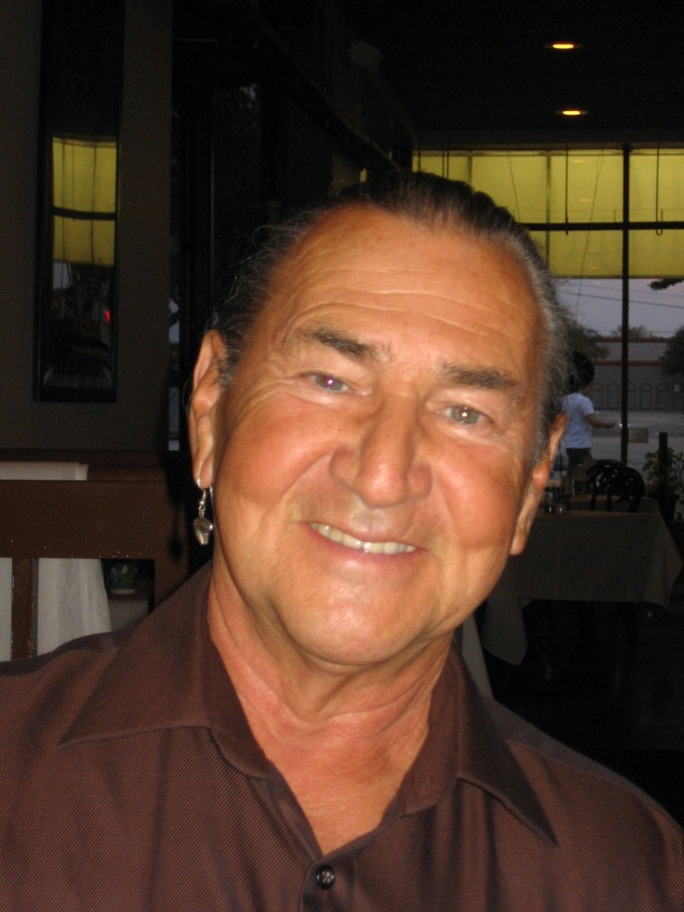 Esteemed Actor August Schellenberg In Brown Shirt Background