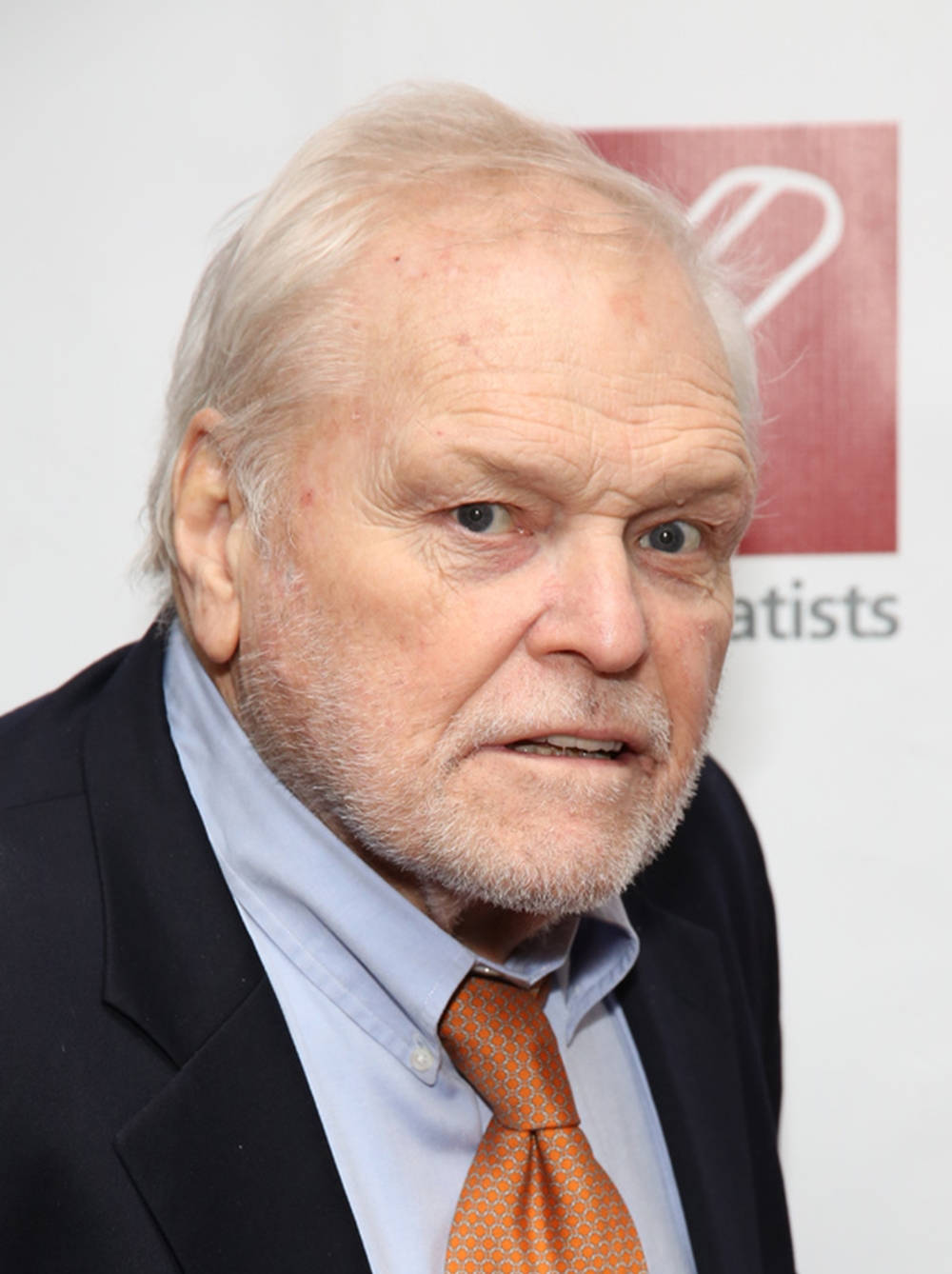 Esteemed Actor Brian Dennehy In Elegant Suit And Tie Background