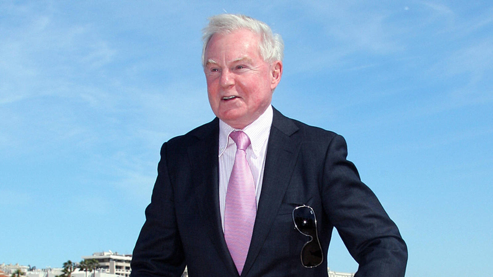 Esteemed Actor Derek Jacobi In Elegant Attire Background