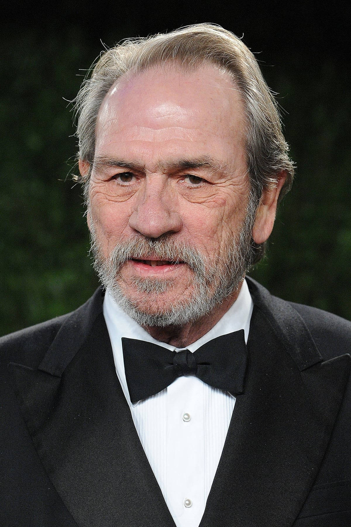 Esteemed Actor Tommy Lee Jones Sporting A Thick White Mustache Background