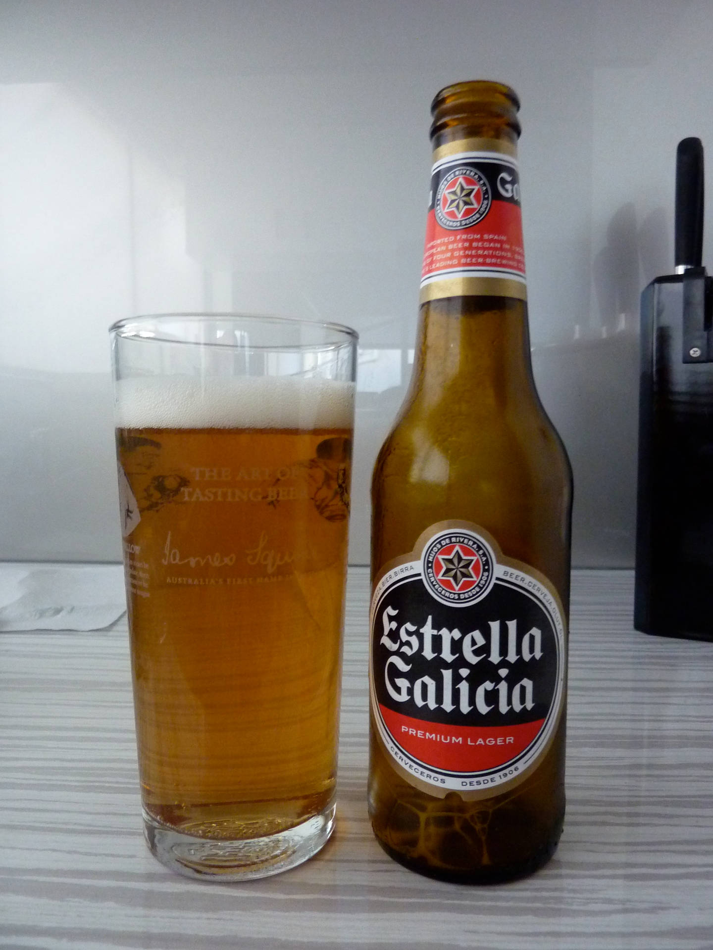 Estrella Lager With A Glass Of Beer Background