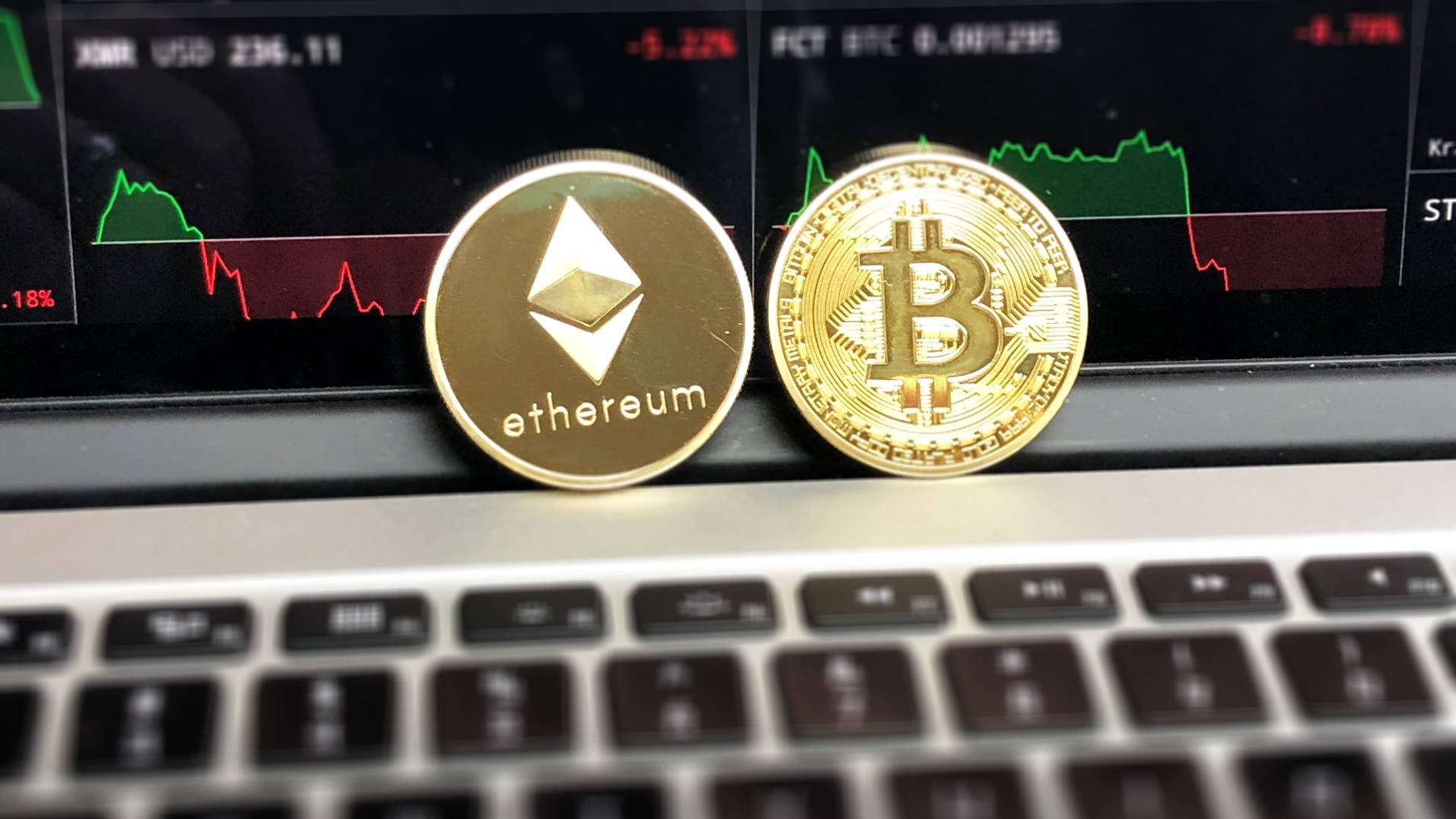 Ethereum And Bitcoin On Laptop Background