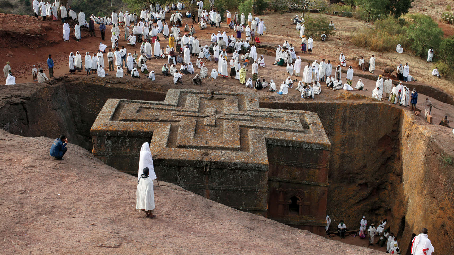 Ethiopian Orthodox Christians Praying At St. George Church In Lalibela Background