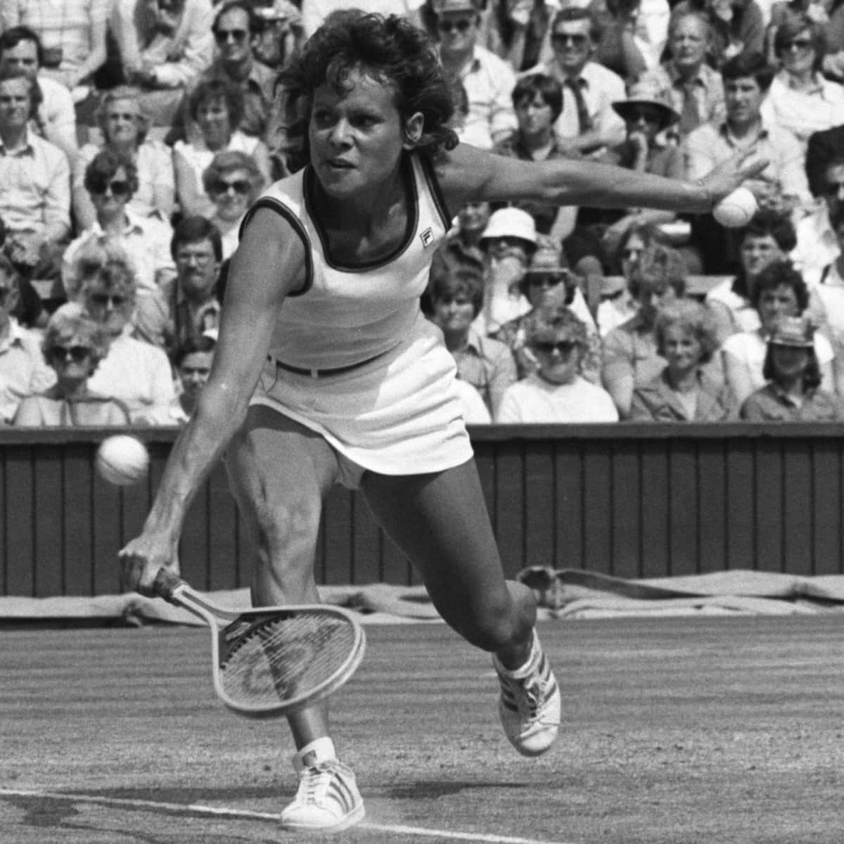 Evonne Goolagong Cawley In Action On The Tennis Court Background