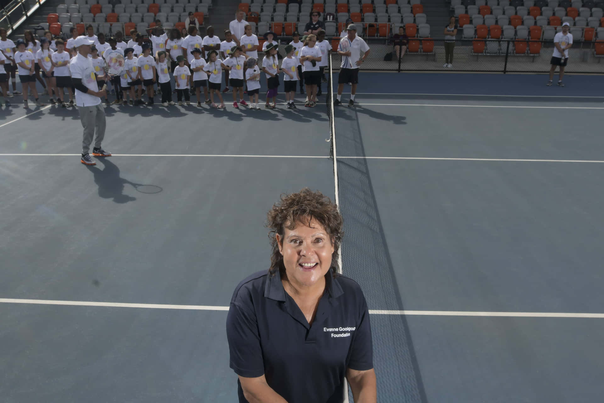 Evonne Goolagong Cawley With Young Tennis Players Background