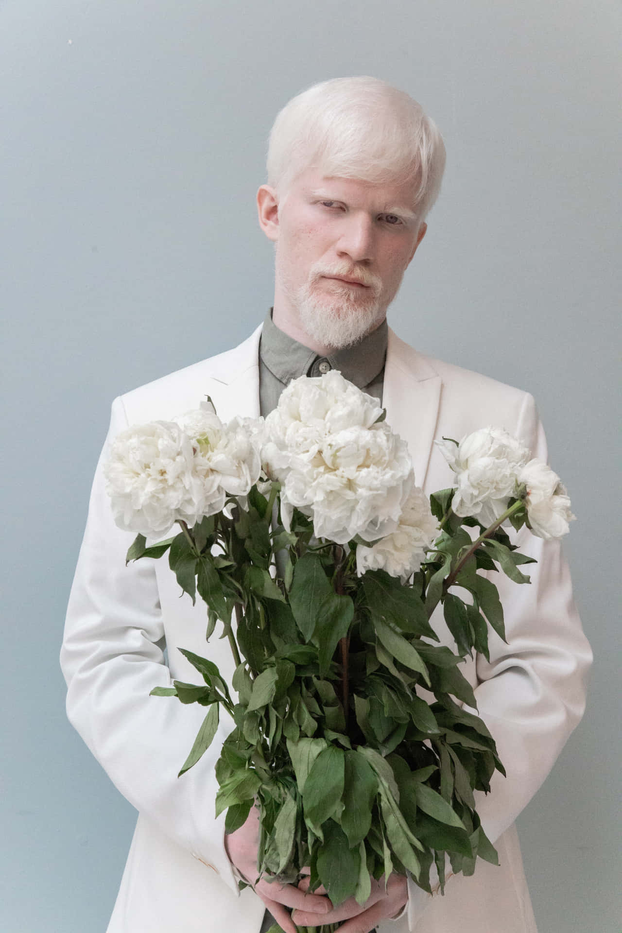 Exceptional Albino Man Holding Flowers Background
