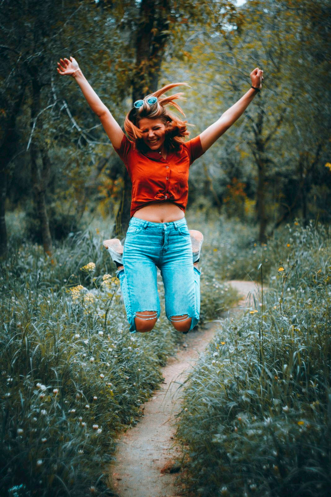 Excited Girl In A Forest Pathway Background