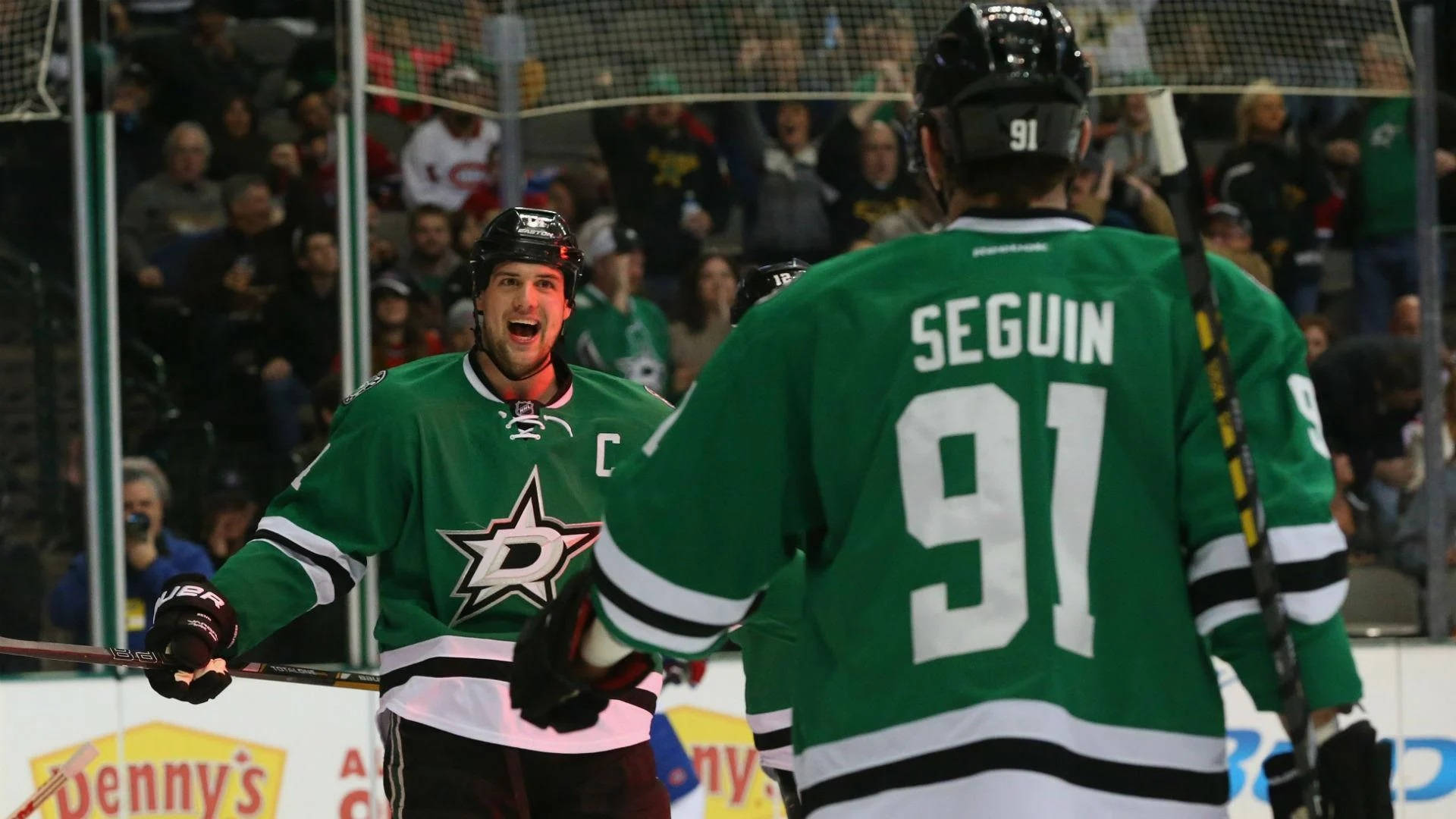 Excited Jamie Benn With Tyler Seguin After An Important Match Background