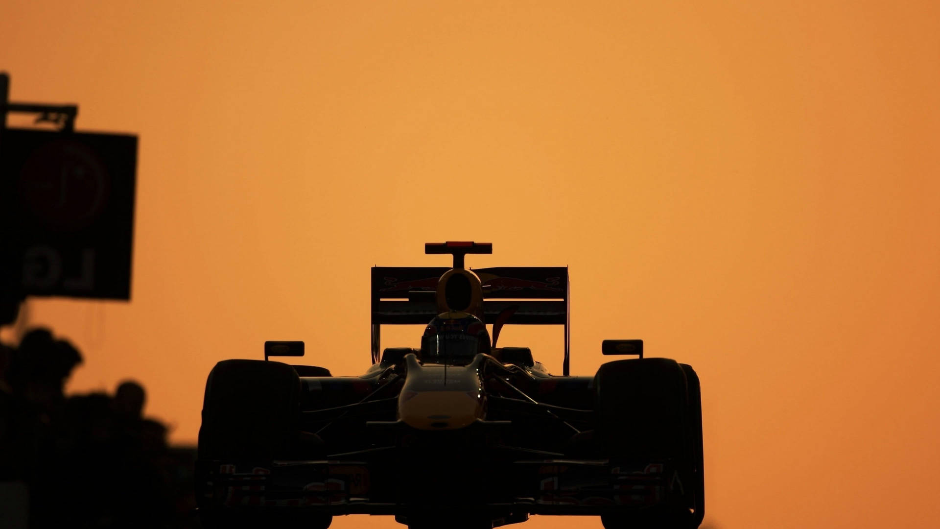 Exciting Action Of F1 Racing Car In Silhouette Background