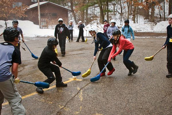 Exciting Family Broomball Match In Action Background