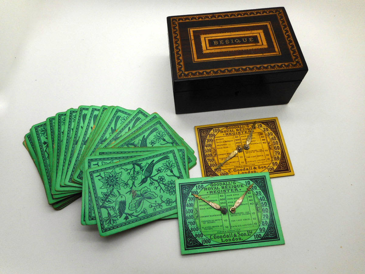 Exciting Game Play With Green And Yellow Bezique Cards Background