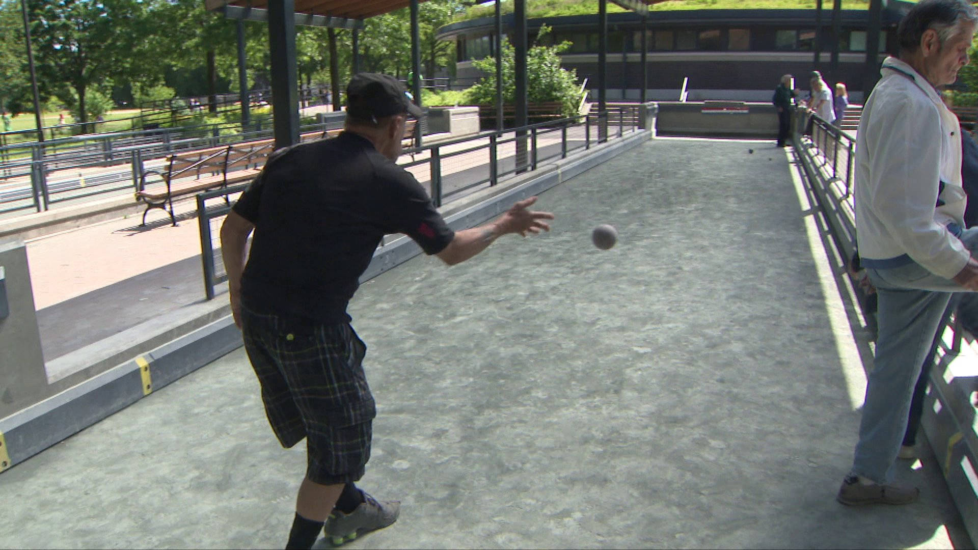 Exciting Moment Of A Bocce Ball Being Thrown On A Court Background