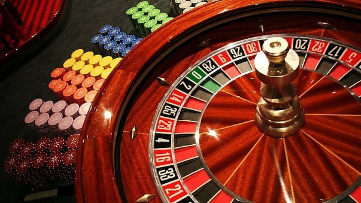 Exciting Spin Of Fortune - Roulette Wheel And Betting Chips Background