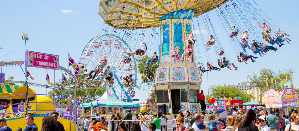 Exciting Tilt-a-whirl Ride At A Vibrant Fair Background