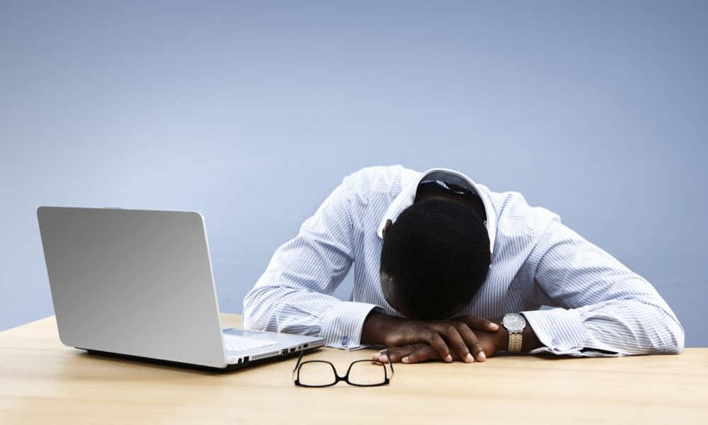 Exhausted Office Worker Restingat Desk Background