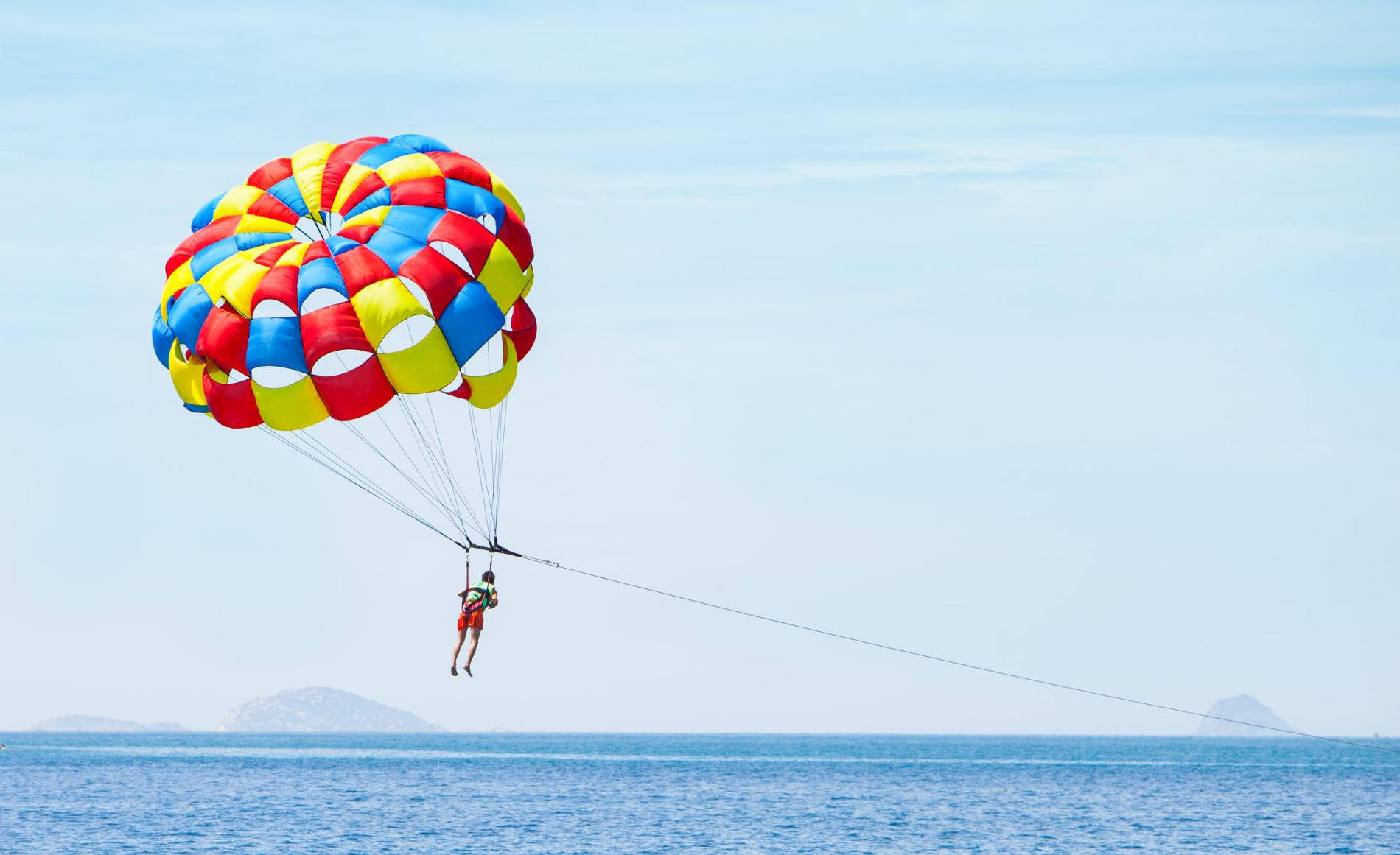 Exhilarating Parasailing Adventure In Snowy Mountains Background