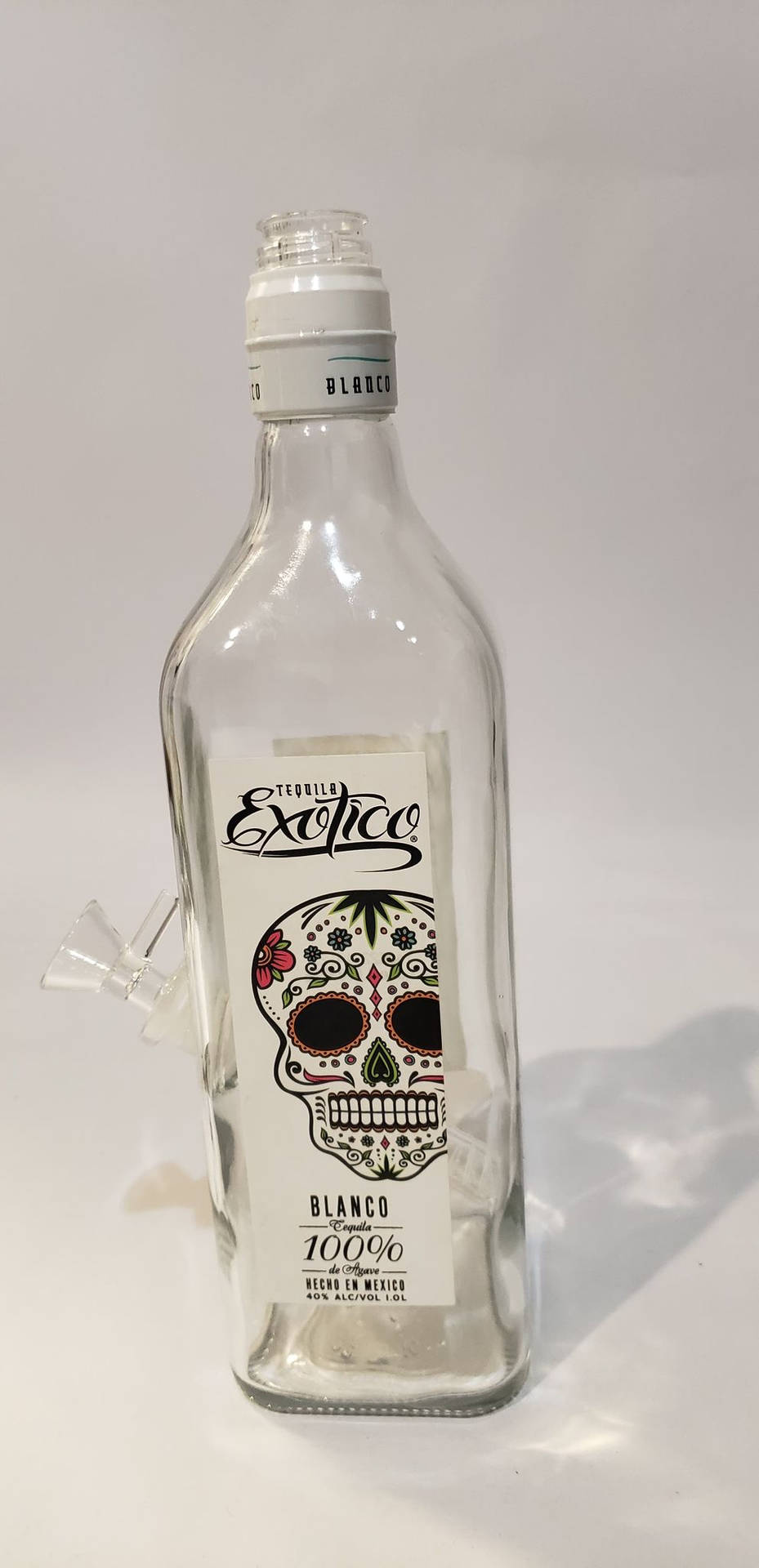 Exotico Tequila Blanco Empty Bottle Background