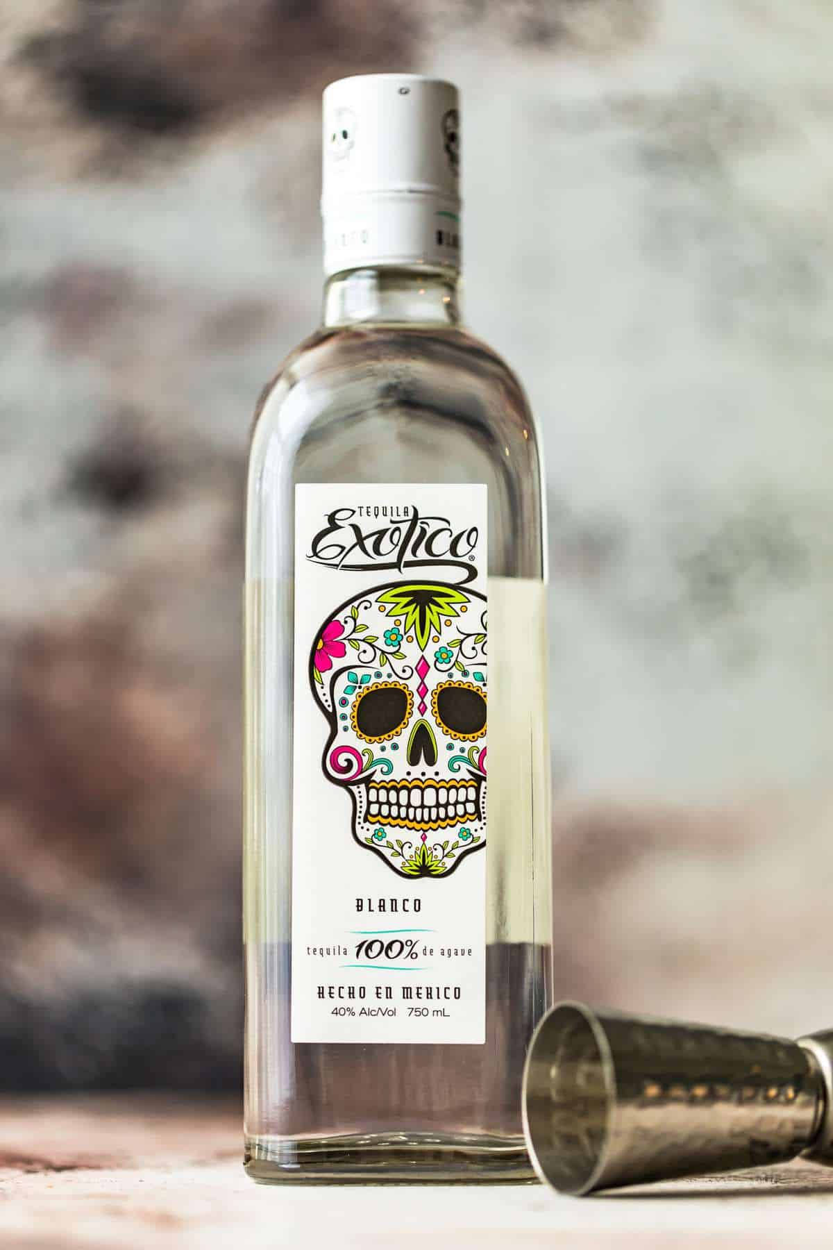 Exotico Tequila Blanco With Jigger Glass Background