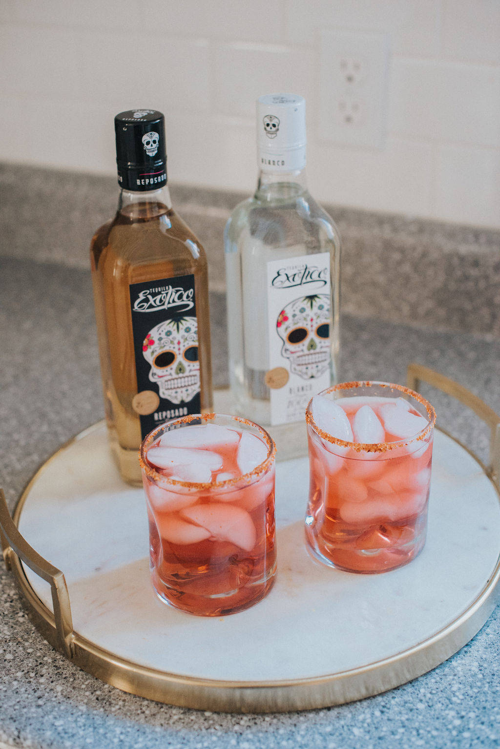 Exotico Tequila With Two Cranberry Cocktails Background