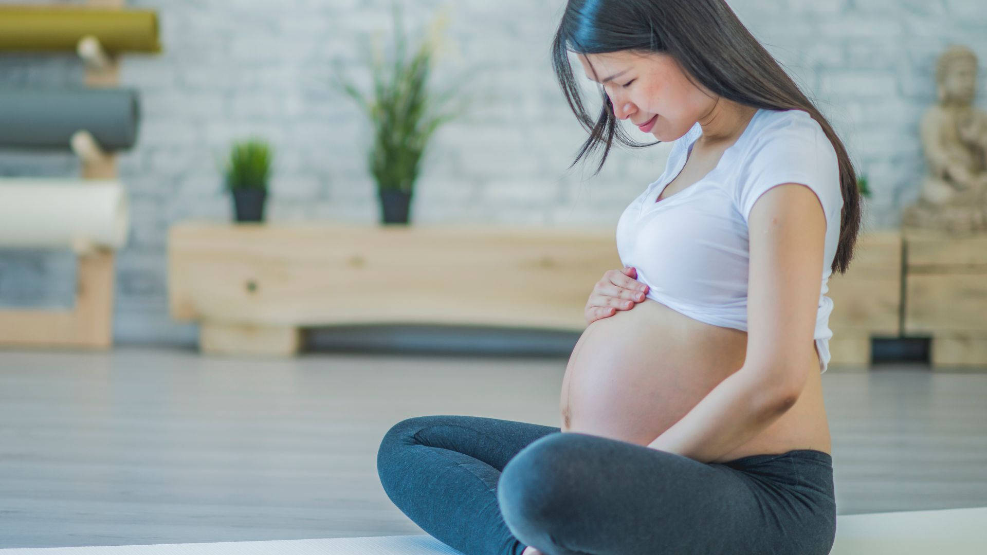 Expectant Mother Embracing Serenity Background