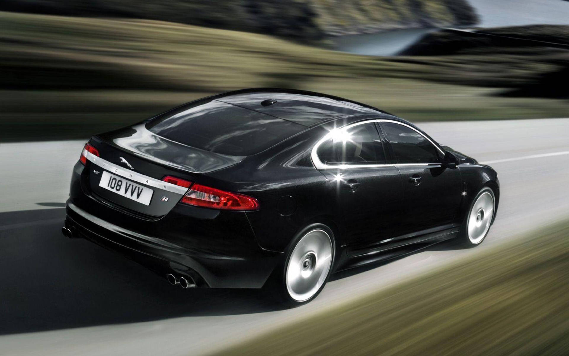 Experience Speed And Luxury With The Black Jaguar Car Background