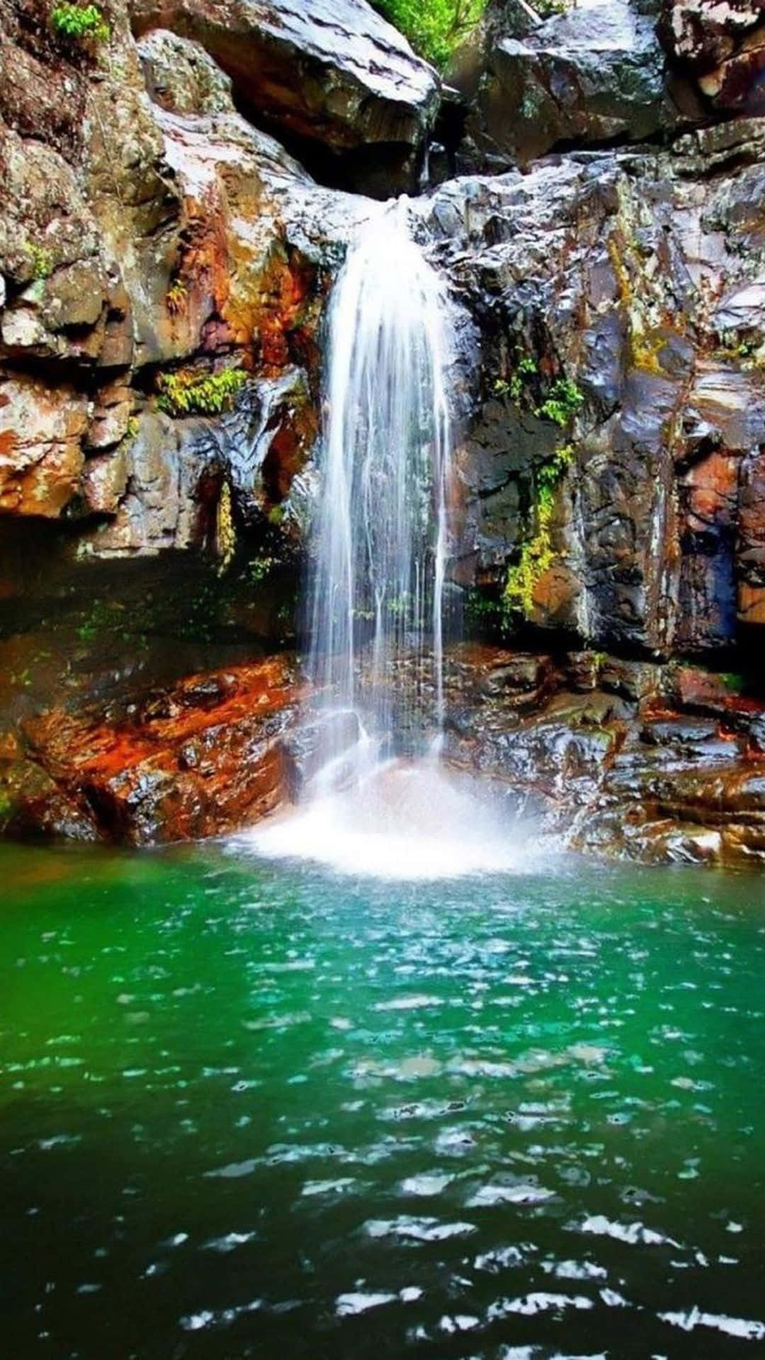 Experience The Beauty Of Nature With This Iphone Waterfall Background