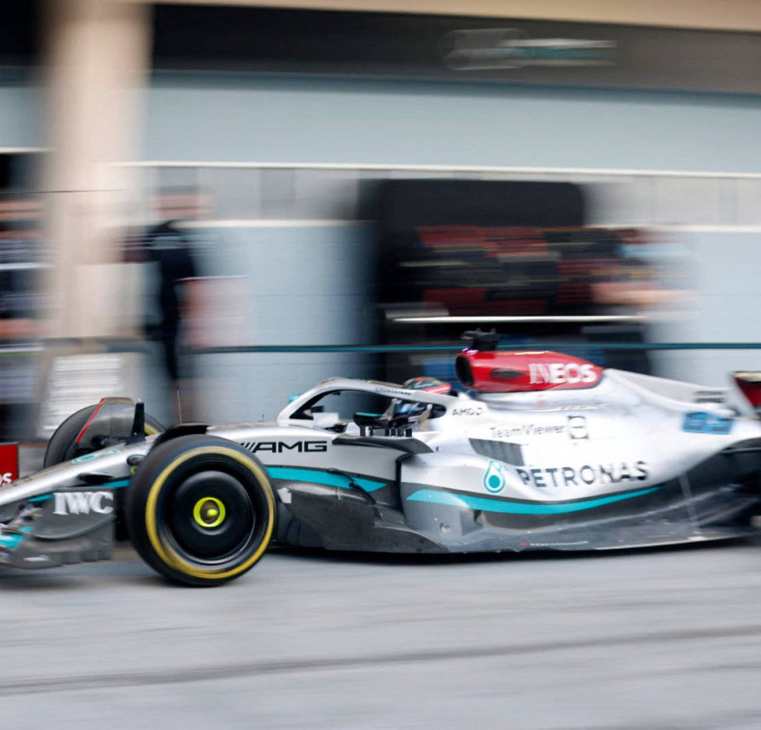 Experience The Excitement Of Mercedes F1 Racing On Your Iphone Background