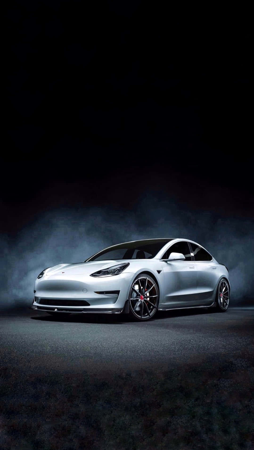 Experience The Functionality And Convenience Of Tesla's Latest Iphone Background
