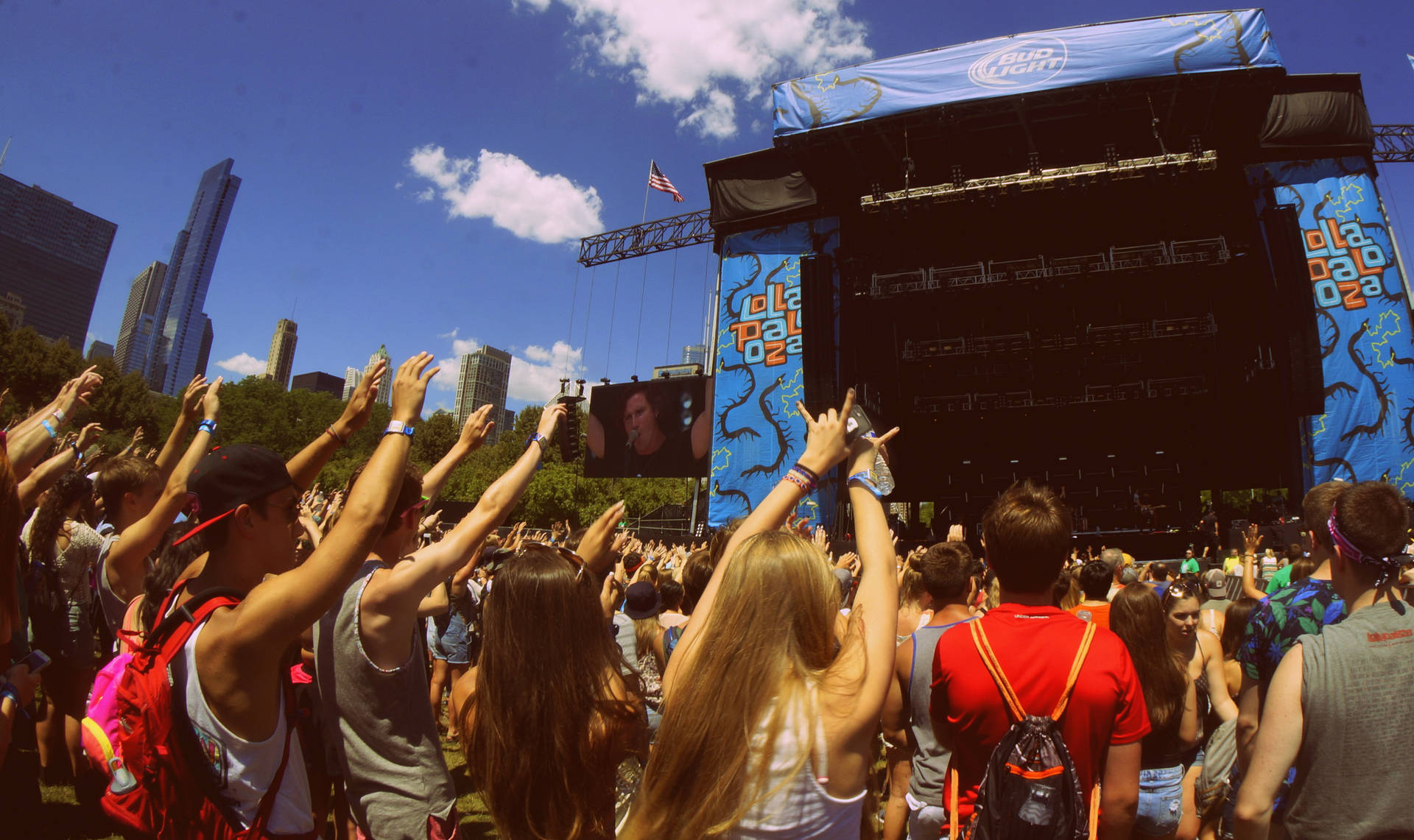 Experience The Magic Of Lollapalooza On The Daytime Stage Background