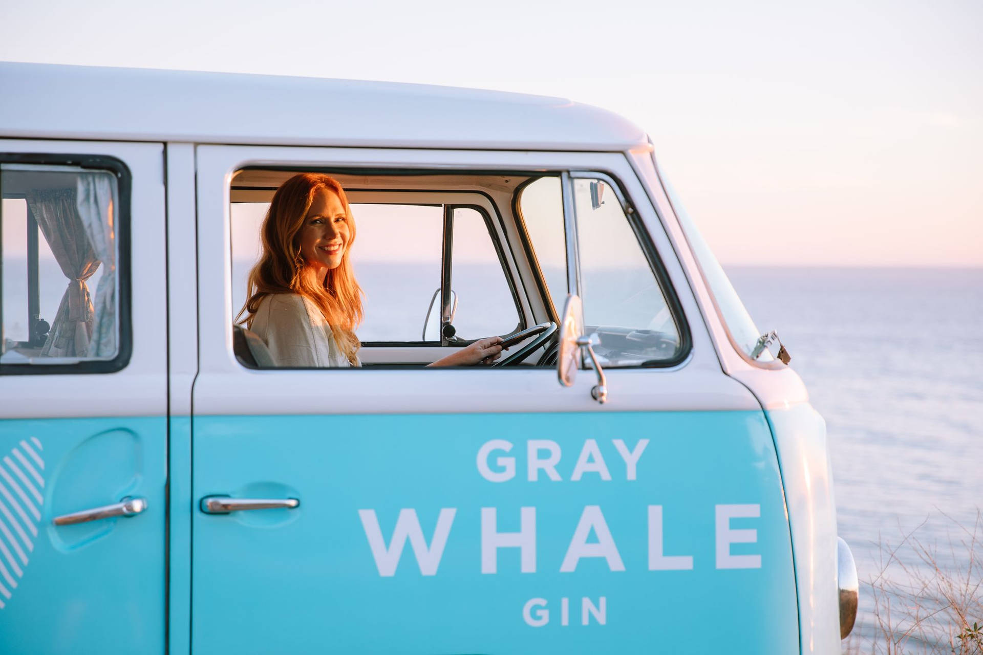 Experience The Serenity With Gray Whale Gin In A Campervan Adventure Background