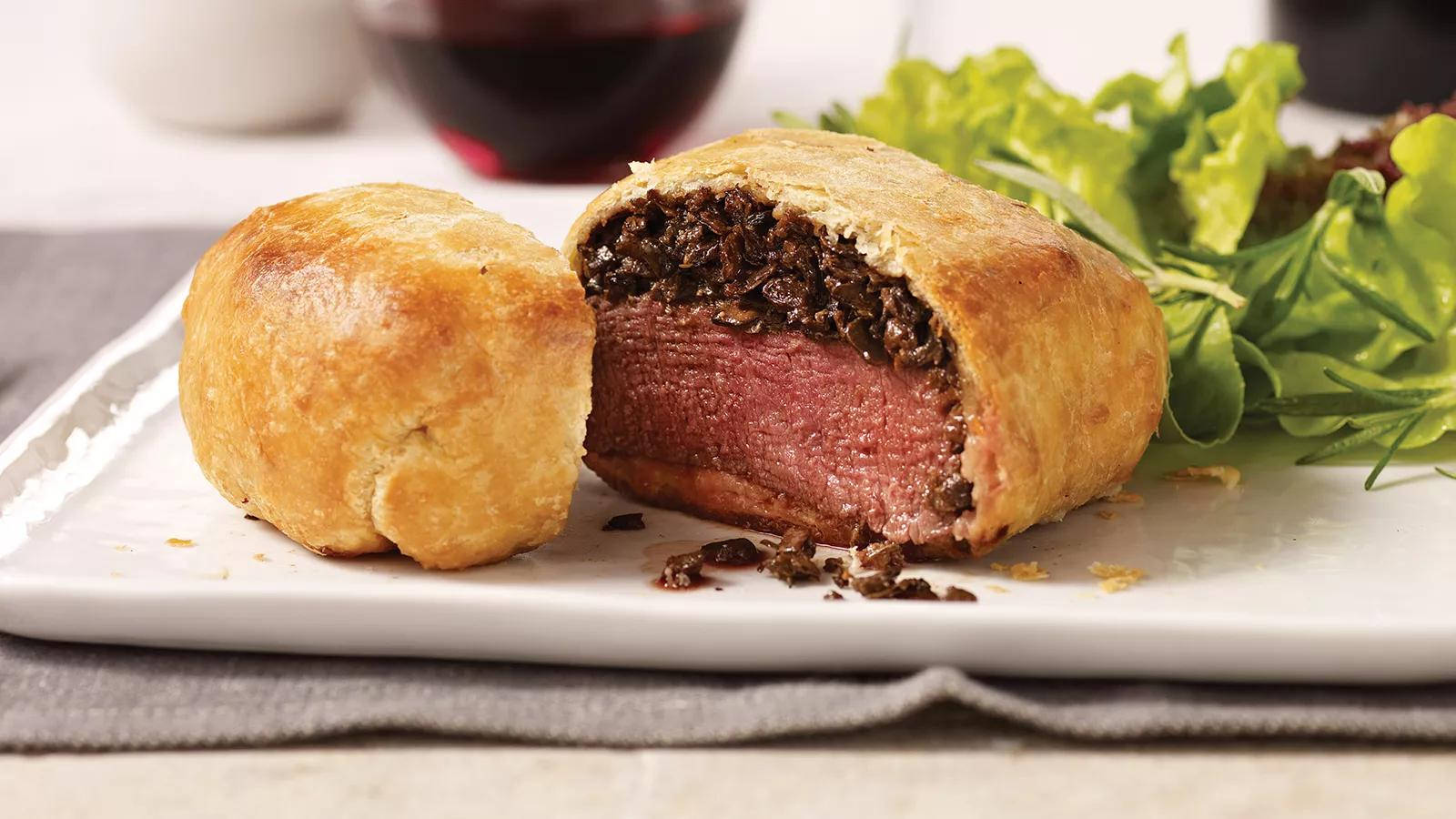 Exquisite Beef Wellington With Leafy Green Garnish Background