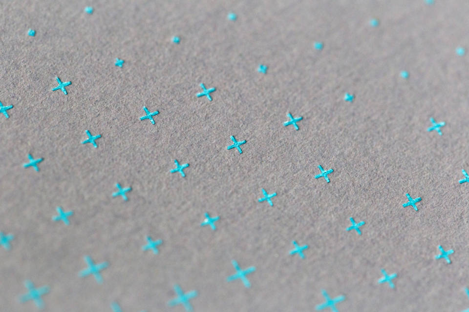 Exquisite Blue Crosses On Gray Paper Texture Background
