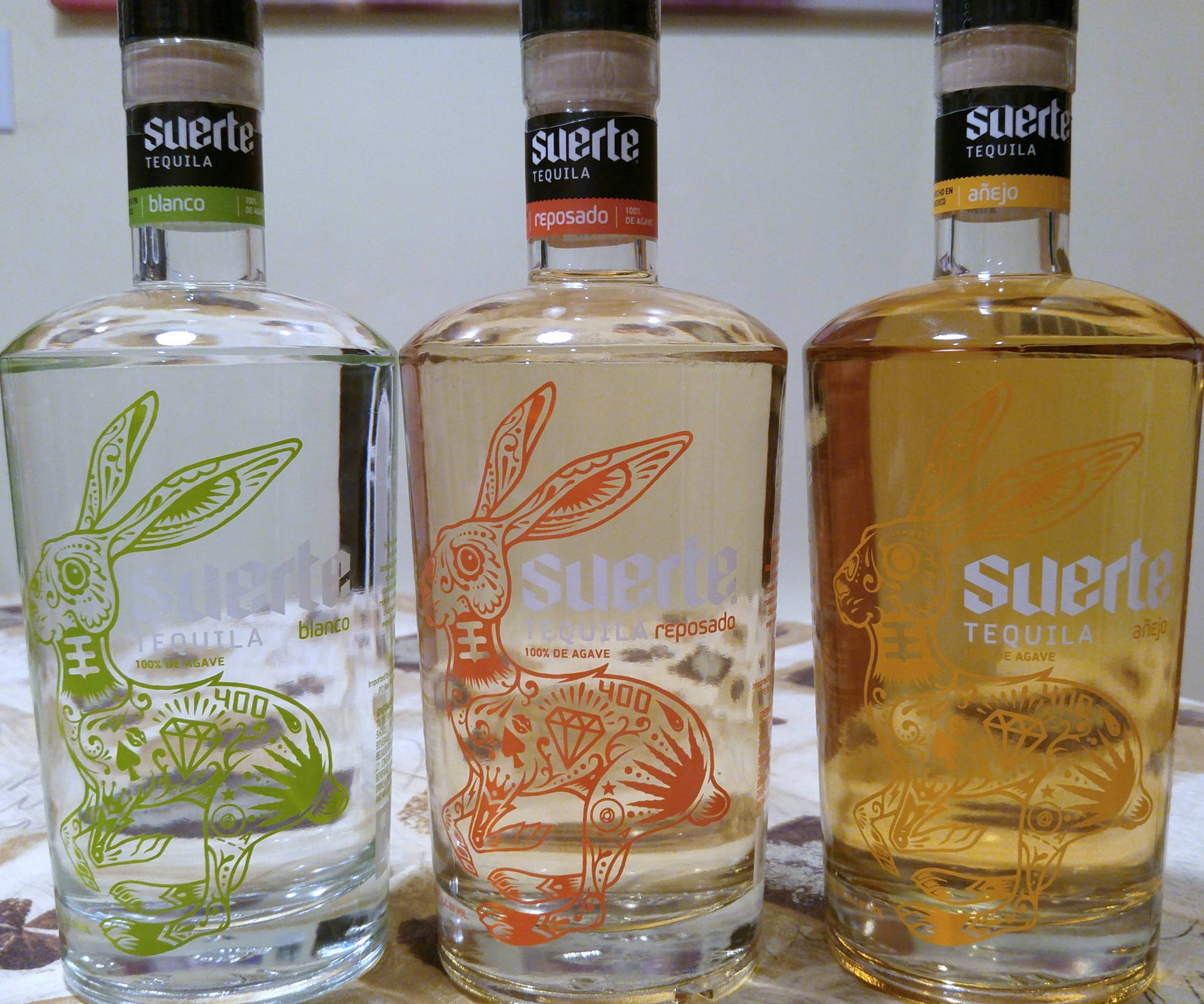 Exquisite Collection Of Suerte Tequila Bottles Background