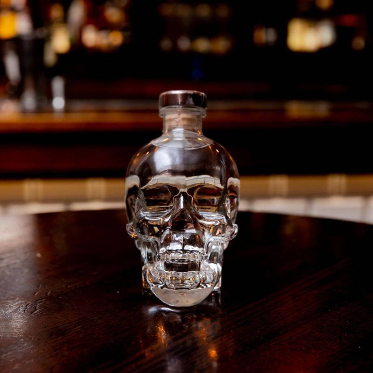 Exquisite Crystal Head Vodka Bottle On An Oak Table Background