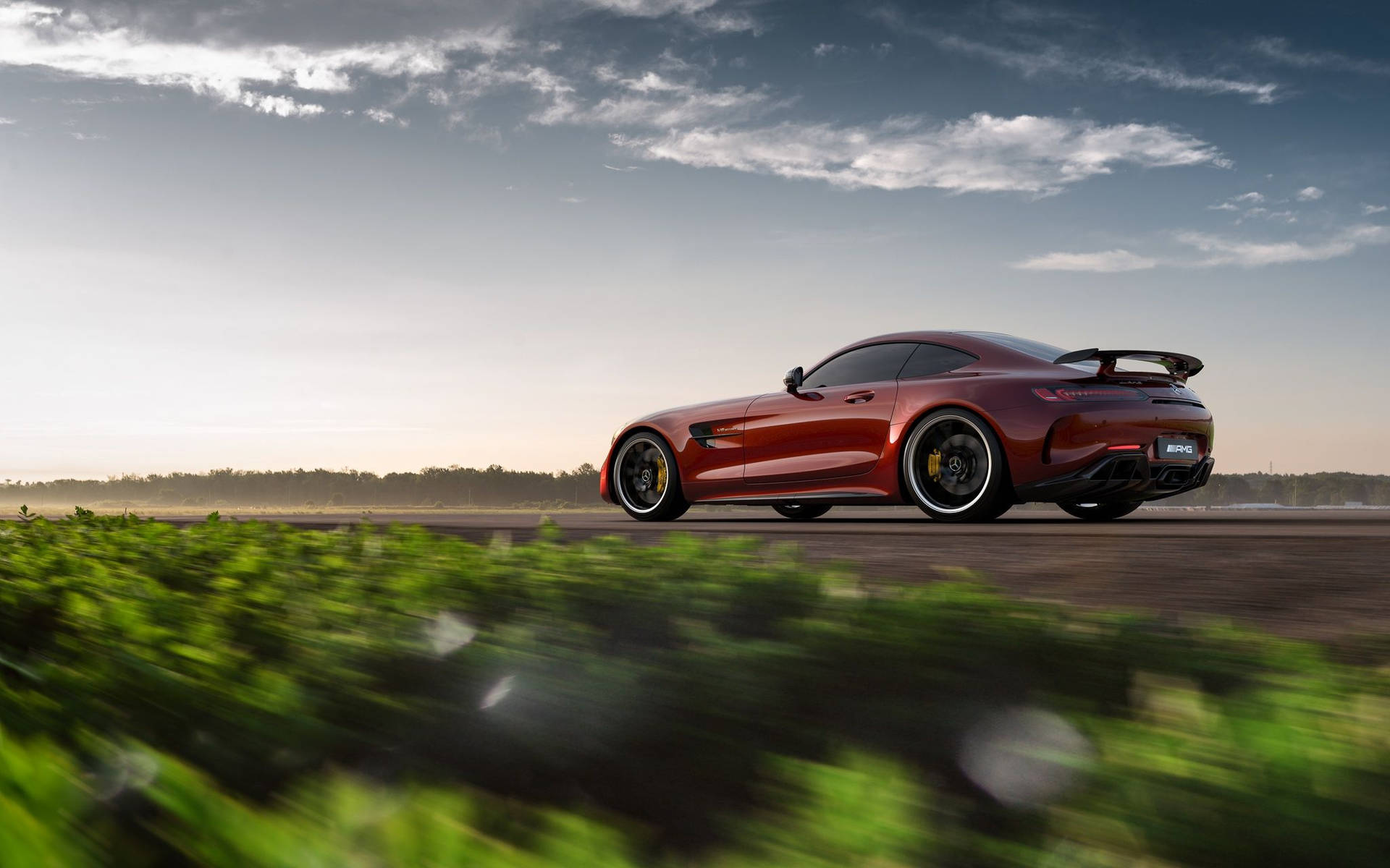 Exquisite Jupiter Red Mercedes Amg Gtr Parked Outdoors Background