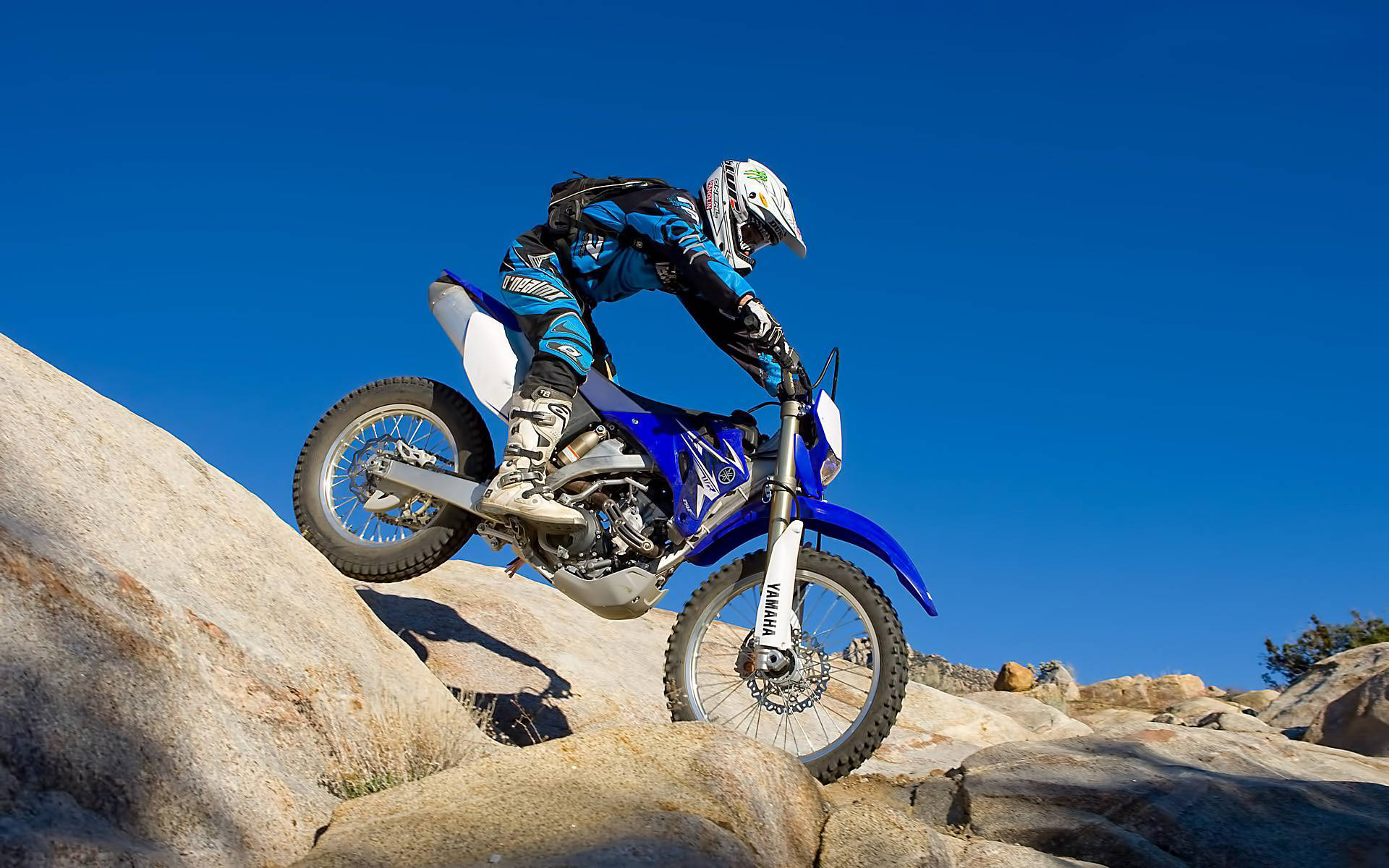 Extreme Motocross Rider In Rocky Scenery Background