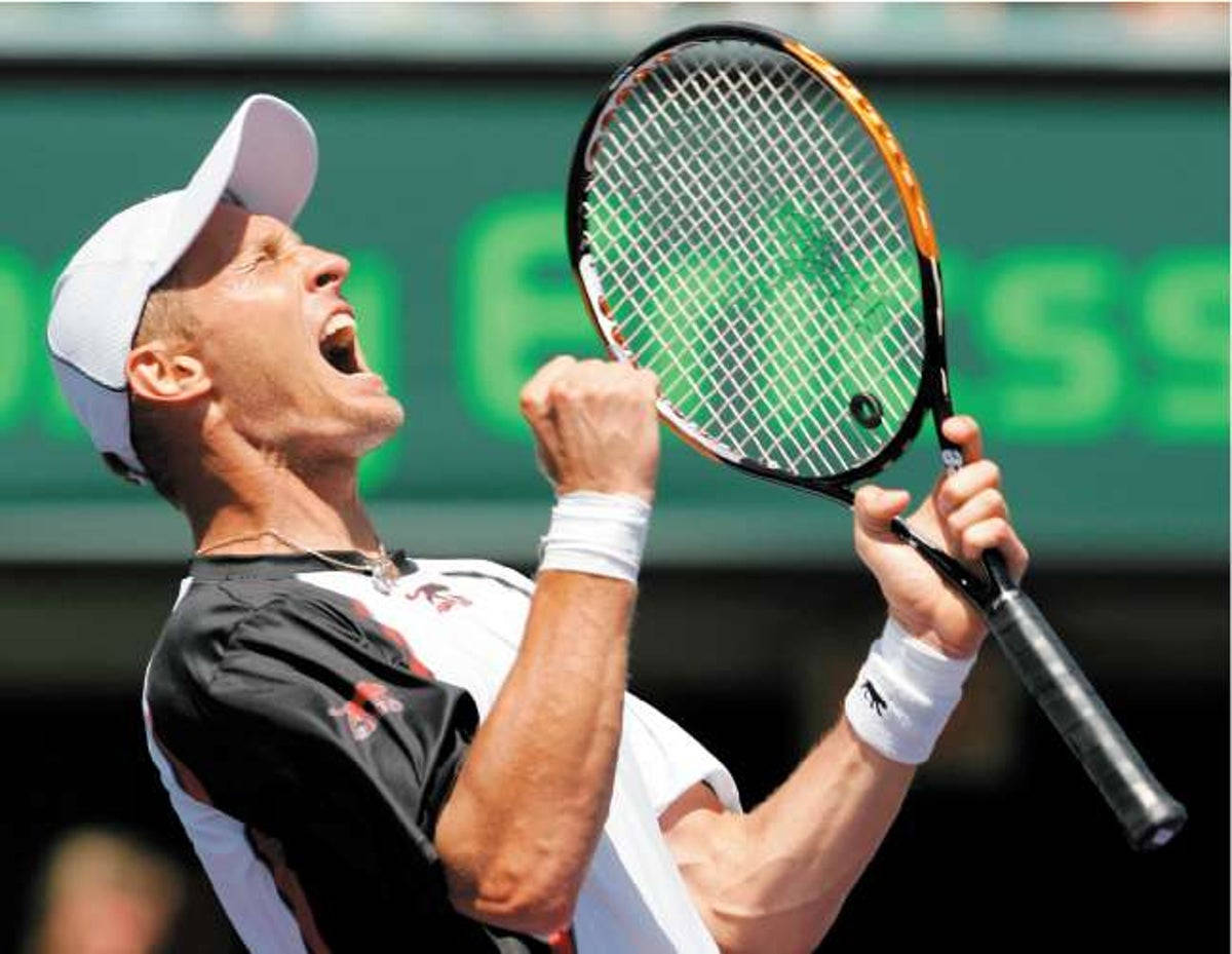 Exuberant Nikolay Davydenko Expressing Joy During A Tennis Match. Background