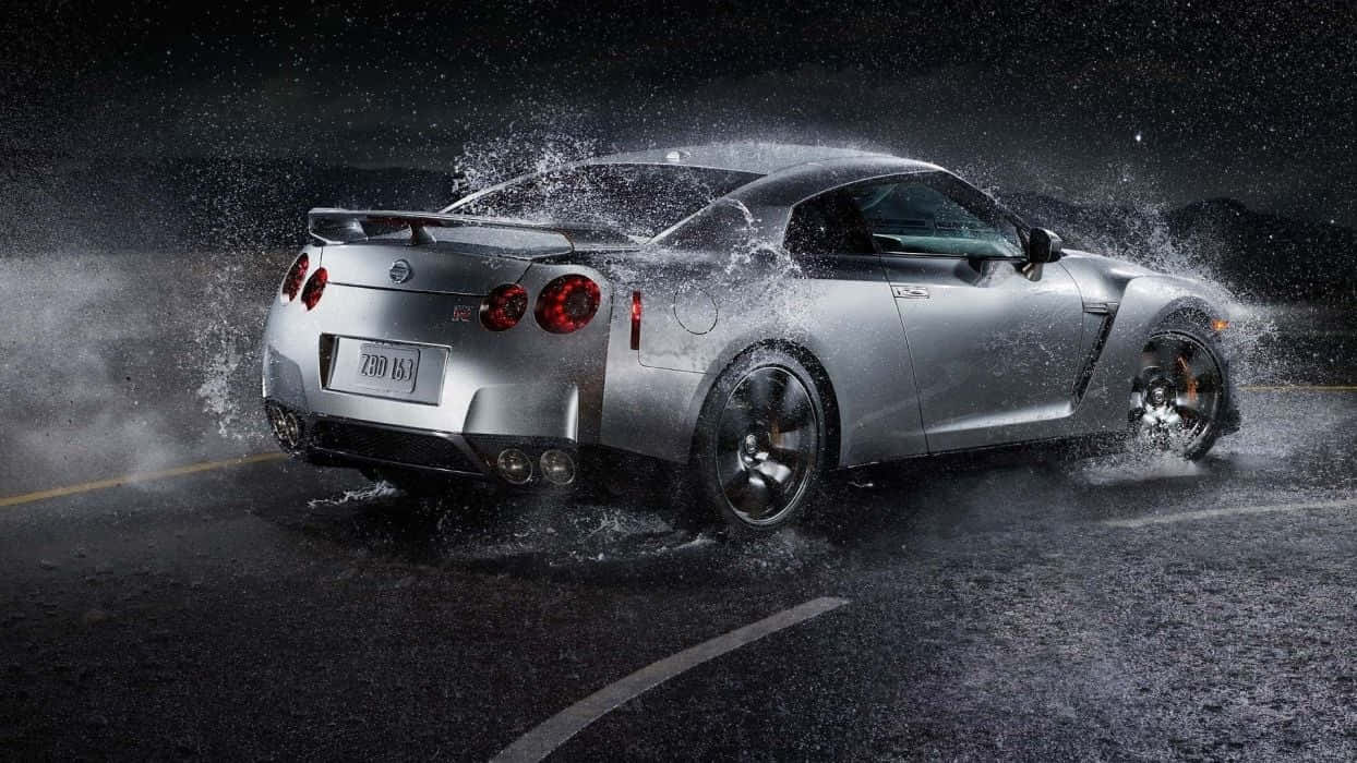 Eye Catching Nissan Gtr R35 Powers Through The Streets Background