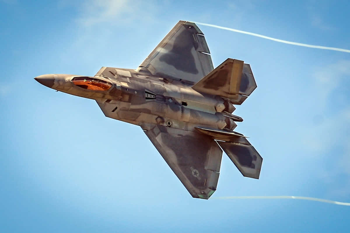 F-22 Raptor Soaring Through The Sky Background